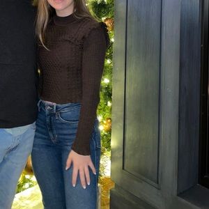 Knit sweater with ruffled shoulder detail